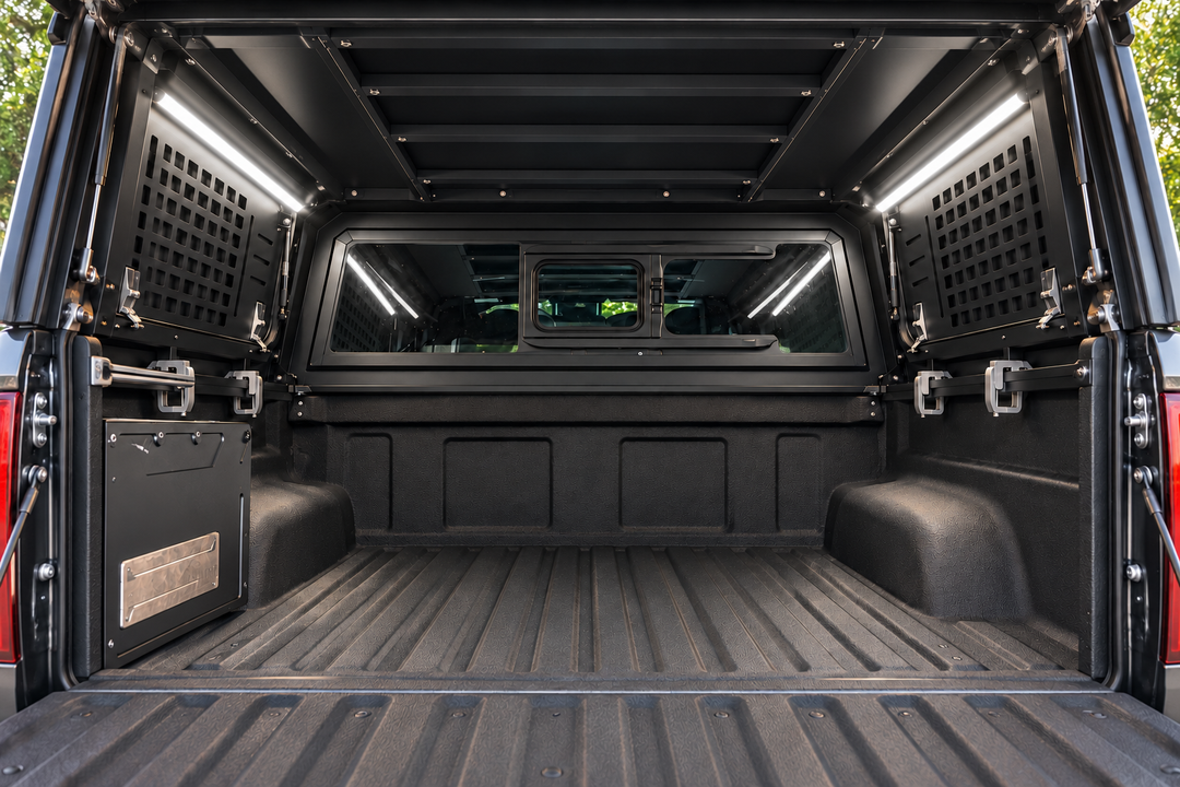 GTFO camper light kit in white mode illuminating an empty truck bed, viewed through the open canopy