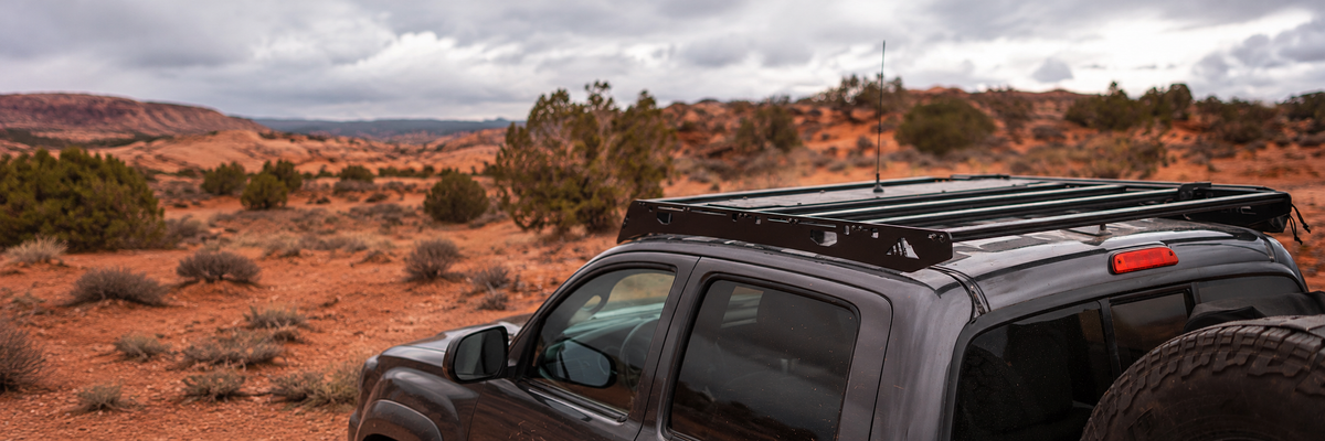 Black Sherpa roof rack mounted on a vehicle in a red-rock desert landscape