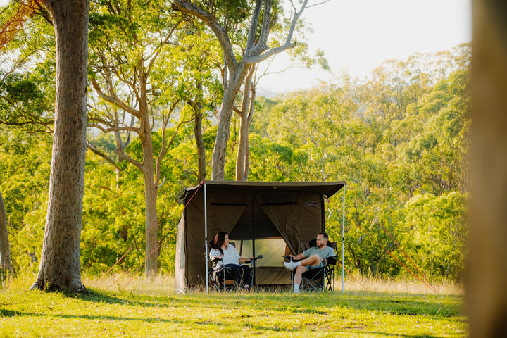 Oztent RV-3 tent with campers seated beneath the awning