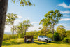 Oztent RV-3 tent and vehicle at a wooded campsite