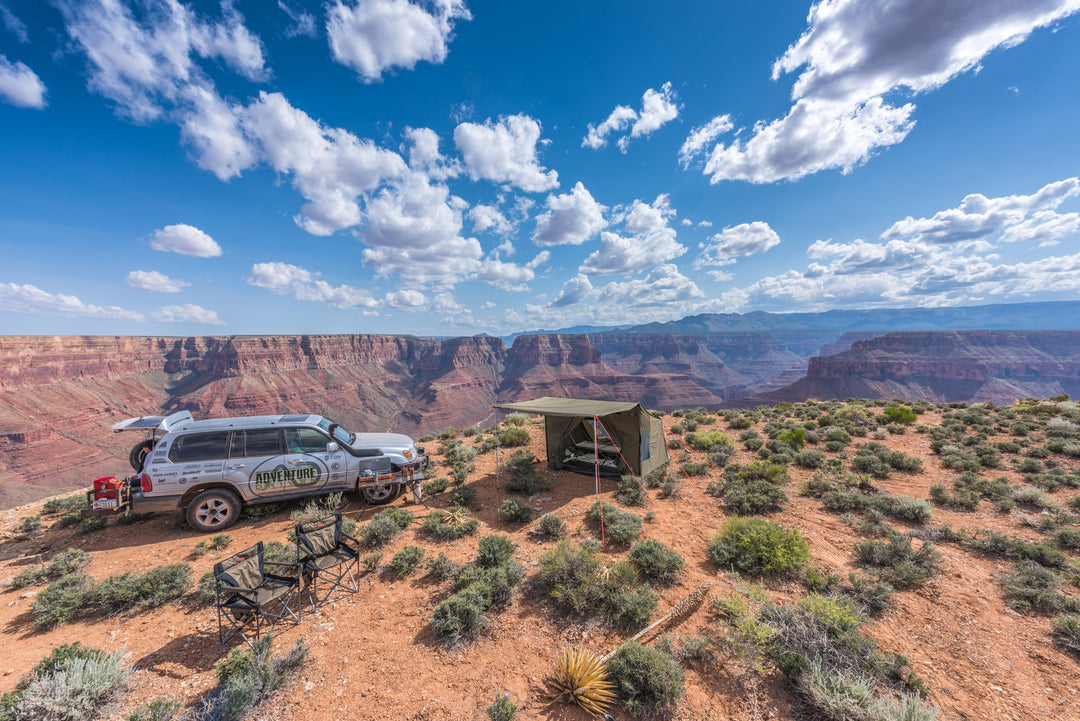 Oztent RV-5 tent and vehicle at a desert canyon campsite