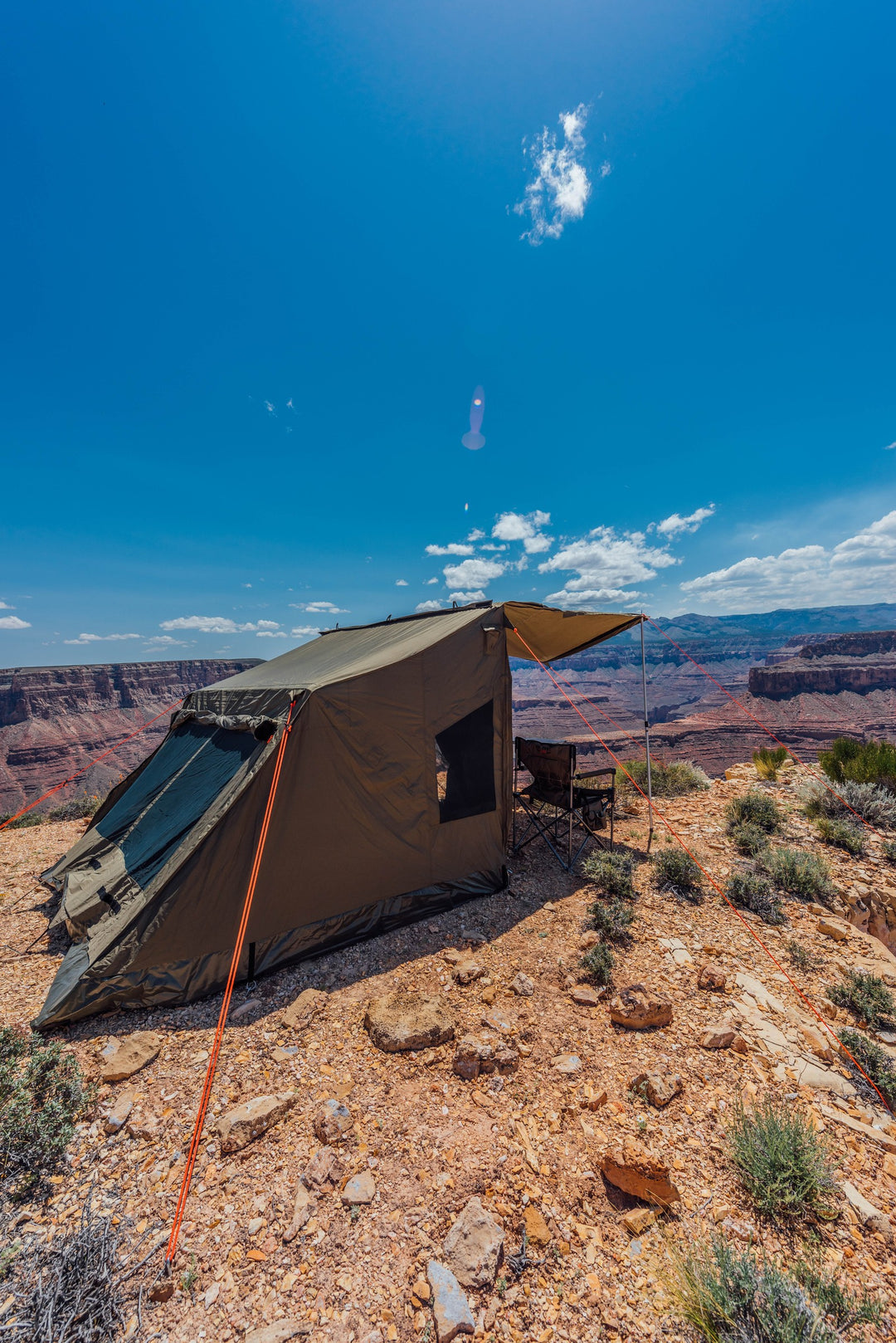 Oztent RV-5 tent set up on rocky terrain above a canyon