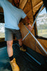 Camper operating the Oztent RV-5 internal folding frame during setup